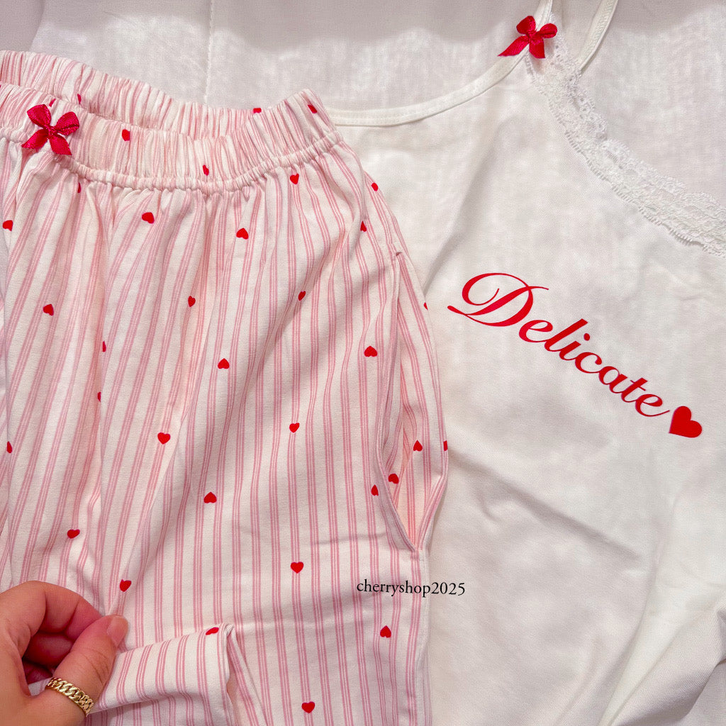 White top and striped salmon trousers with heart print