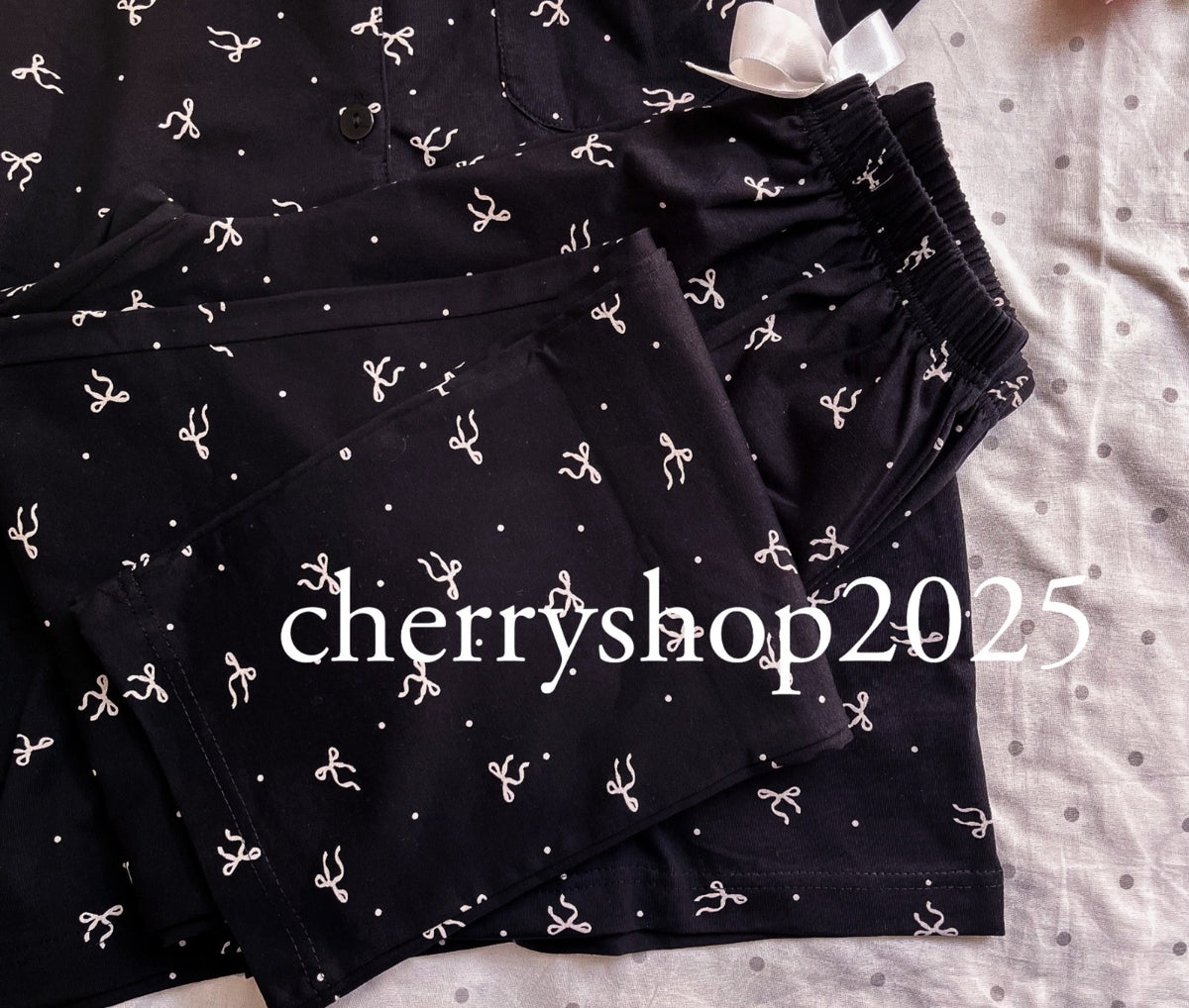 Pajamas with short sleeves, buttons, and a black bow