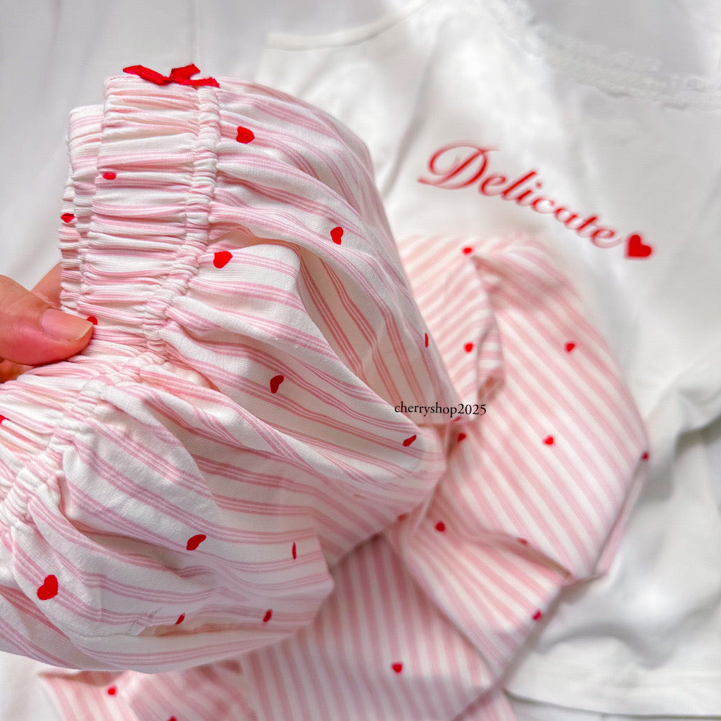 White top and striped salmon trousers with heart print