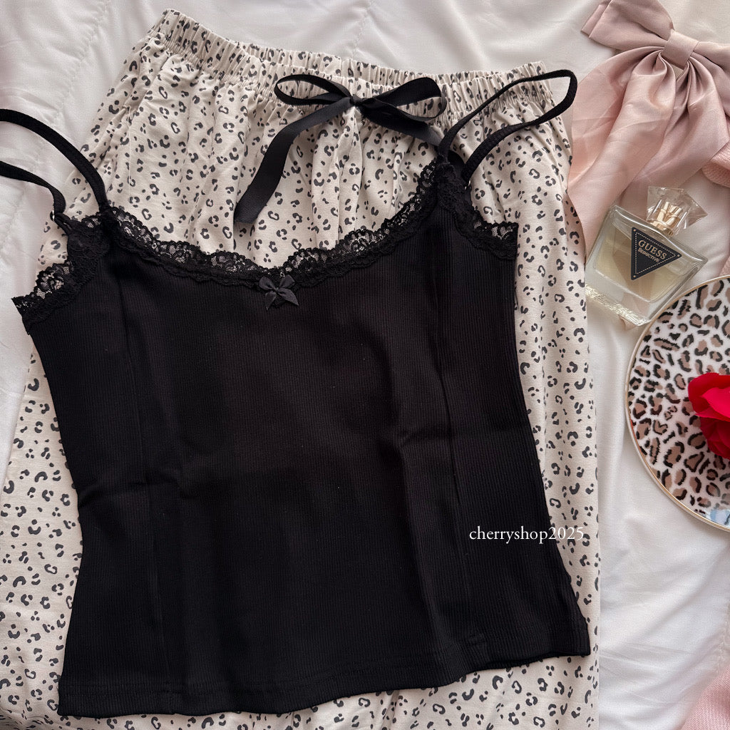 Black top and beige tiger pants