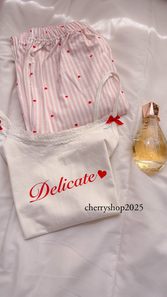 White top and striped salmon trousers with heart print
